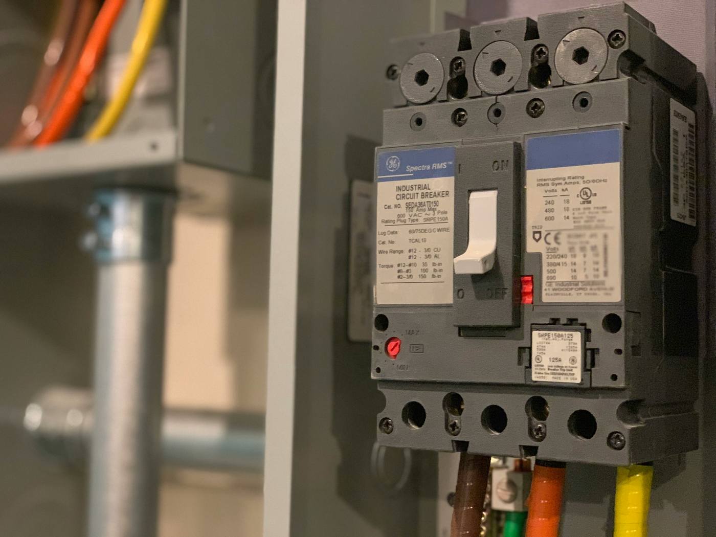 Industrial three-pole circuit breaker mounted in a commercial distribution panel